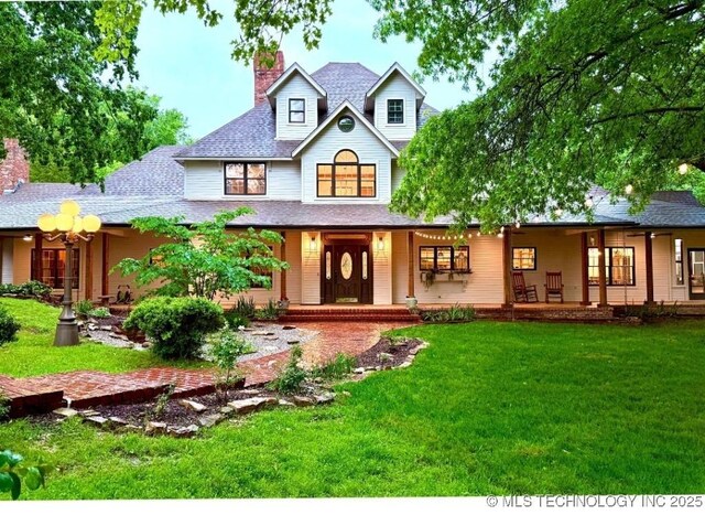 15373 N Javine Hill Rd, Skiatook, OK 74070 - rear view of house with a porch, a chimney, a lawn, and a shingled roof