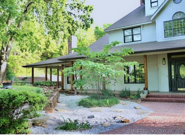 15373 N Javine Hill Rd, Skiatook, OK 74070 - entrance to property featuring roof with shingles, a chimney, and covered porch