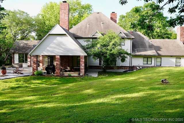 15373 N Javine Hill Rd, Skiatook, OK 74070 - back of property with a patio, a yard, a chimney, and brick siding