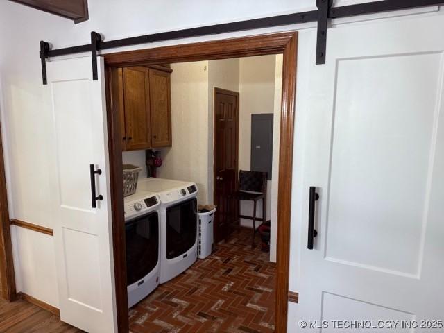 15373 N Javine Hill Rd, Skiatook, OK 74070 - laundry room with a barn door, cabinet space, separate washer and dryer, and brick patterned floors