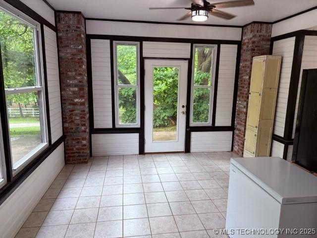 15373 N Javine Hill Rd, Skiatook, OK 74070 - entryway with brick wall, a ceiling fan, and light tile patterned floors