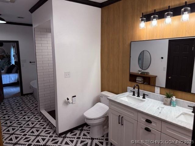 15373 N Javine Hill Rd, Skiatook, OK 74070 - full bathroom featuring toilet, a stall shower, double vanity, ornamental molding, and wooden walls