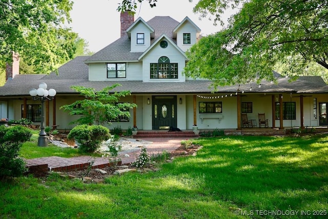 15373 N Javine Hill Rd, Skiatook, OK 74070 - view of front facade with a porch, a chimney, a front lawn, and a shingled roof