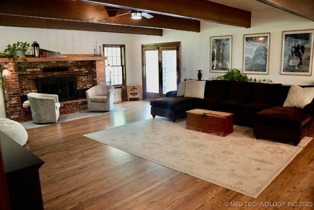 15373 N Javine Hill Rd, Skiatook, OK 74070 - living area with a ceiling fan, beam ceiling, wood finished floors, and a fireplace