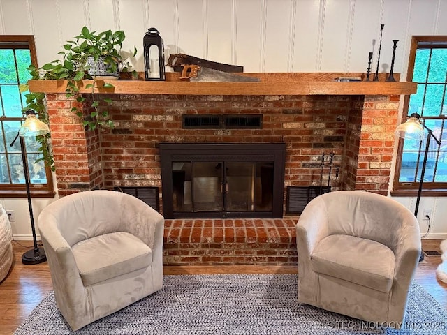 15373 N Javine Hill Rd, Skiatook, OK 74070 - sitting room featuring a brick fireplace, plenty of natural light, and wood finished floors