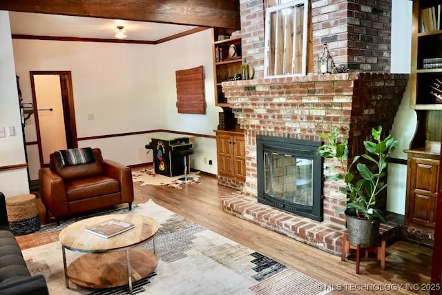 15373 N Javine Hill Rd, Skiatook, OK 74070 - living room with wood finished floors, a brick fireplace, and ornamental molding