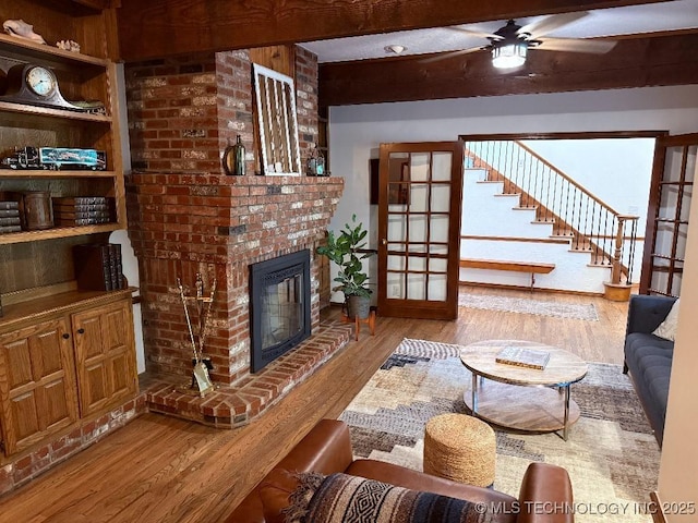 15373 N Javine Hill Rd, Skiatook, OK 74070 - living area featuring wood finished floors, a ceiling fan, and a fireplace