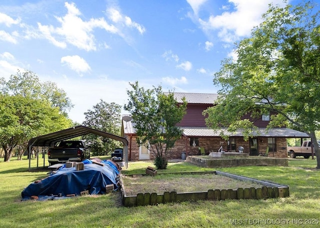311 Washington Ave, Boswell, OK 74727 - rear view of property featuring a yard, a detached carport, metal roof, and brick siding