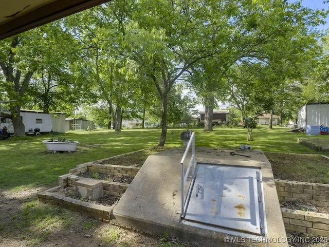 311 Washington Ave, Boswell, OK 74727 - entry to storm shelter featuring a lawn