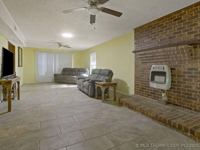 311 Washington Ave, Boswell, OK 74727 - living area featuring heating unit, ceiling fan, a textured ceiling, baseboards, and light stone finish flooring
