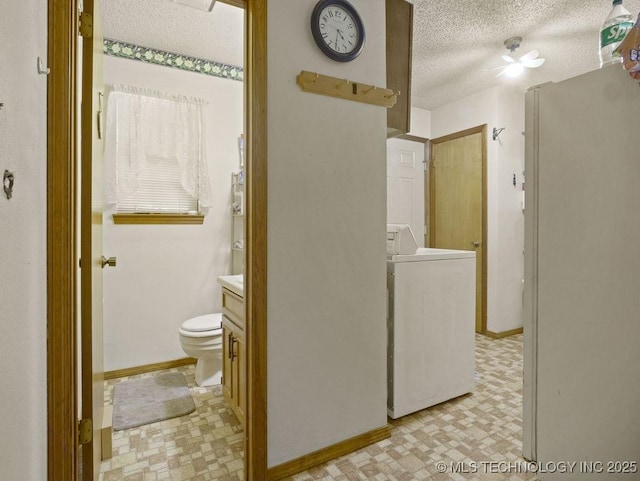 311 Washington Ave, Boswell, OK 74727 - bathroom with washer / clothes dryer, a textured ceiling, toilet, baseboards, and tile patterned floors