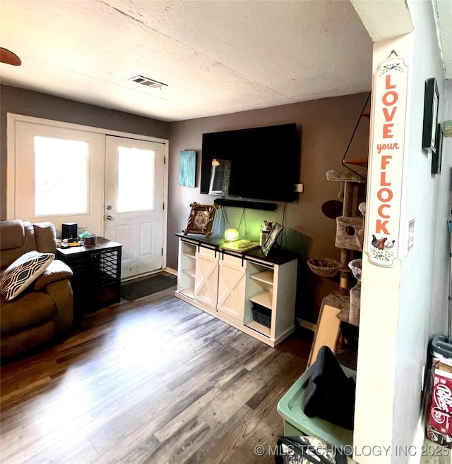 1715 Worley, Durant, OK 74701 - living room featuring wood finished floors and a textured ceiling