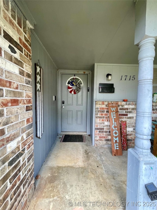1715 Worley, Durant, OK 74701 - doorway to property featuring a porch and brick siding