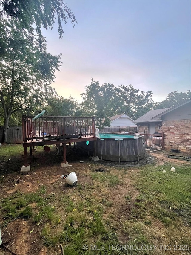 1715 Worley, Durant, OK 74701 - yard at dusk with a wooden deck