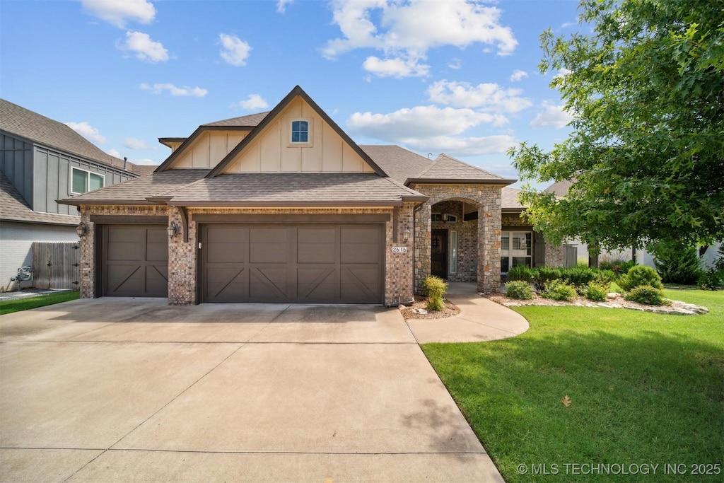 2616 E 136th St S, Bixby, OK 74008 - view of front of property with board and batten siding, a front yard, concrete driveway, an attached garage, and brick siding