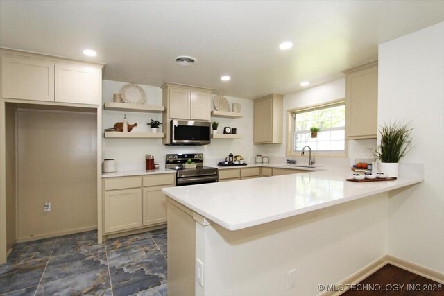 6112 E 21st St, Tulsa, OK 74114 - kitchen with stainless steel appliances, open shelves, a peninsula, light countertops, and baseboards
