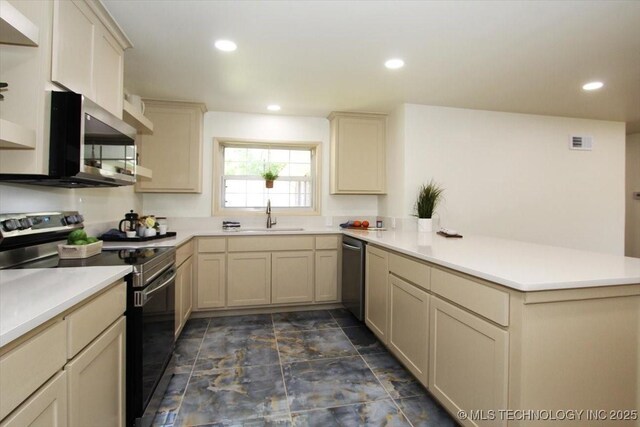 6112 E 21st St, Tulsa, OK 74114 - kitchen featuring appliances with stainless steel finishes, a peninsula, light countertops, a sink, and recessed lighting
