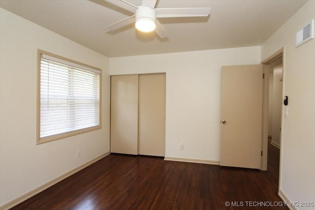 6112 E 21st St, Tulsa, OK 74114 - unfurnished bedroom featuring wood finished floors, a closet, baseboards, and a ceiling fan