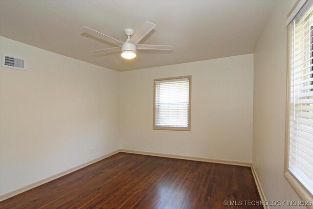 6112 E 21st St, Tulsa, OK 74114 - empty room featuring dark wood finished floors, plenty of natural light, baseboards, and a ceiling fan