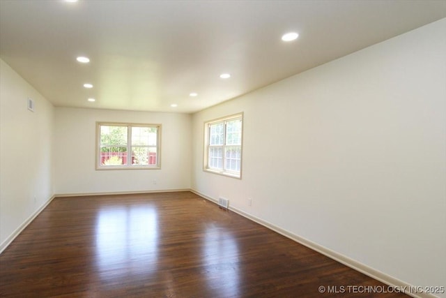 6112 E 21st St, Tulsa, OK 74114 - spare room featuring recessed lighting, dark wood-style floors, and baseboards