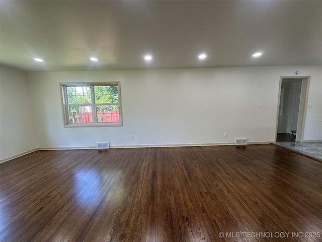 6112 E 21st St, Tulsa, OK 74114 - empty room with dark wood finished floors, recessed lighting, and baseboards