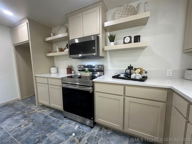 6112 E 21st St, Tulsa, OK 74114 - kitchen featuring stainless steel appliances, open shelves, light countertops, and dark marble finish flooring