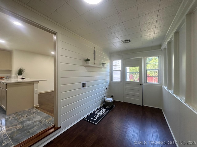 6112 E 21st St, Tulsa, OK 74114 - doorway to outside with wood finished floors, baseboards, and wood walls