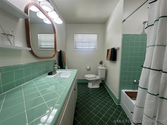 6112 E 21st St, Tulsa, OK 74114 - bathroom featuring vanity, toilet, tile patterned flooring, and shower / bath combo with shower curtain