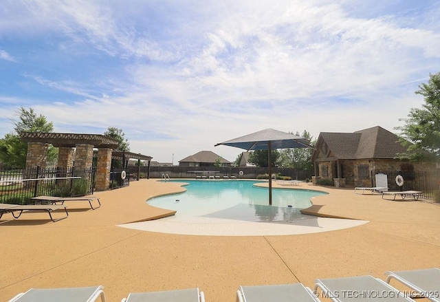 community pool featuring a patio area, fence, and a pergola