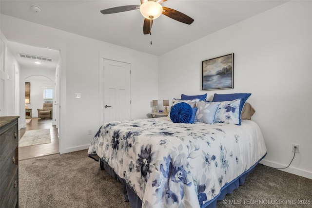 2621 S Catalayah Ln, Claremore, OK 74019 - bedroom featuring carpet, arched walkways, baseboards, and a ceiling fan