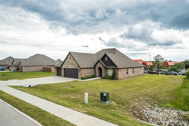 2621 S Catalayah Ln, Claremore, OK 74019 - french country style house featuring brick siding, a garage, a front lawn, driveway, and a shingled roof