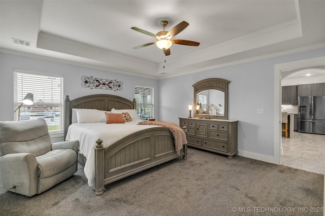 2621 S Catalayah Ln, Claremore, OK 74019 - bedroom featuring stainless steel fridge, a tray ceiling, crown molding, baseboards, and light carpet