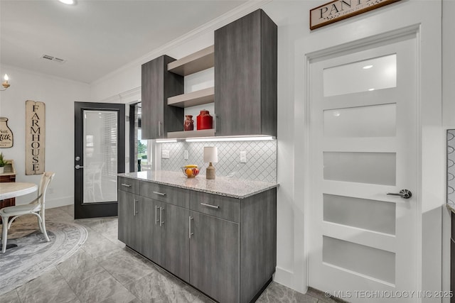 2621 S Catalayah Ln, Claremore, OK 74019 - kitchen with open shelves, crown molding, decorative backsplash, light marble finish flooring, and light stone countertops