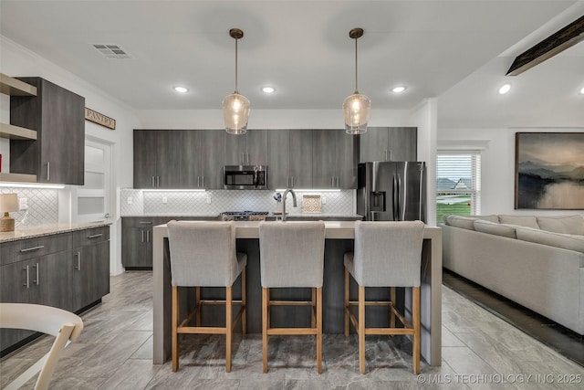2621 S Catalayah Ln, Claremore, OK 74019 - kitchen with stainless steel appliances, open shelves, modern cabinets, a breakfast bar area, and recessed lighting