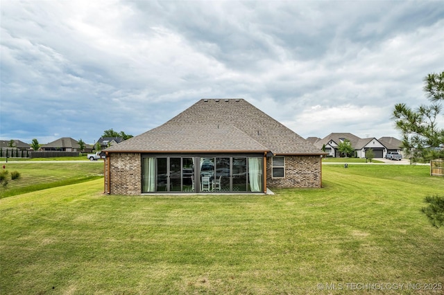 2621 S Catalayah Ln, Claremore, OK 74019 - back of house with a yard, brick siding, and roof with shingles