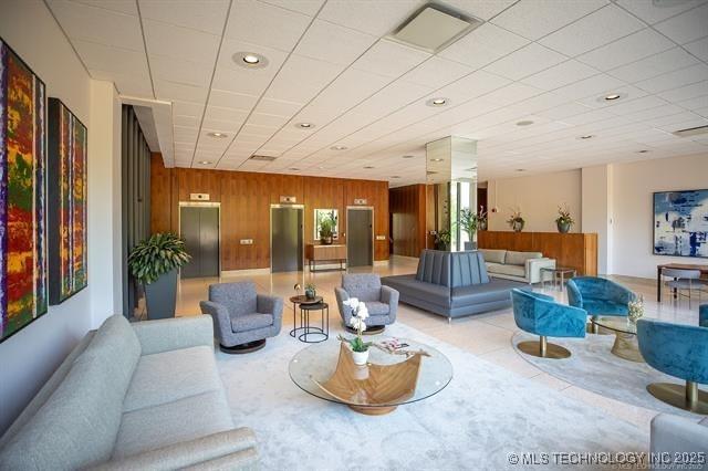 building lobby featuring recessed lighting and wooden walls
