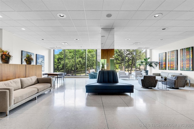 community lobby with a wall of windows and recessed lighting