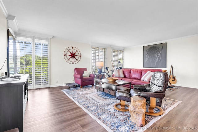 living area featuring crown molding, wood finished floors, and baseboards