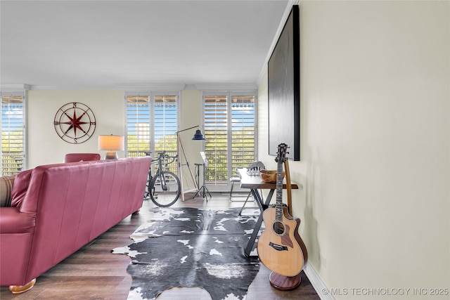 living area with wood finished floors and baseboards