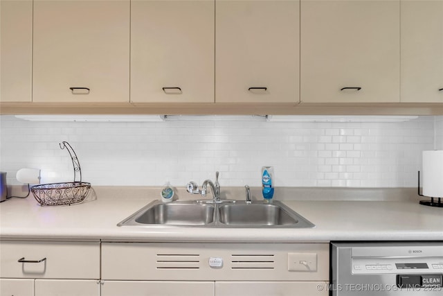 kitchen with dishwasher, a sink, light countertops, backsplash, and cream cabinetry