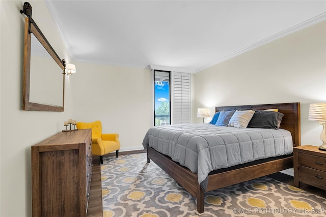bedroom with ornamental molding, wood finished floors, and baseboards