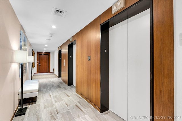 corridor with elevator and recessed lighting