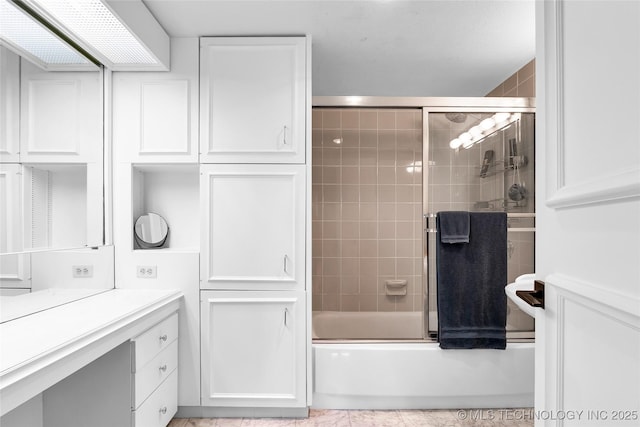 full bathroom with combined bath / shower with glass door and vanity