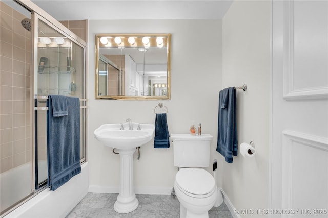 full bath with bath / shower combo with glass door, toilet, and baseboards