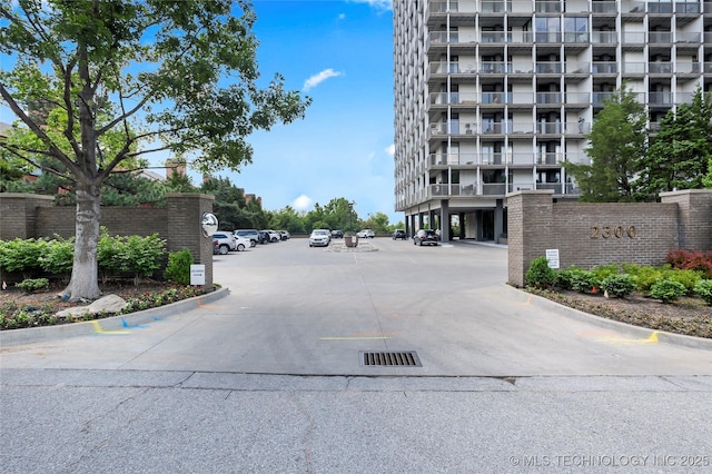 view of apartment building / complex with uncovered parking