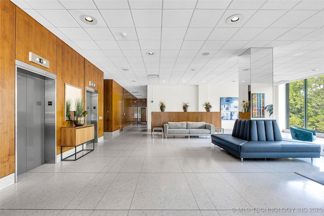 community lobby with wooden walls and recessed lighting