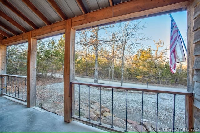 555 Williams Dr, Eufaula, OK 74432 - unfurnished sunroom featuring view of wooded area