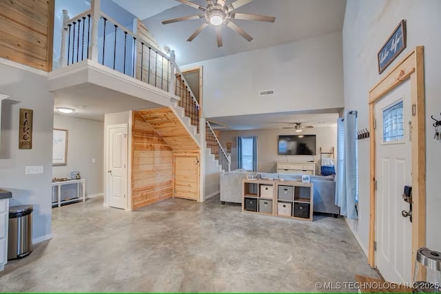 555 Williams Dr, Eufaula, OK 74432 - entryway with a ceiling fan, a high ceiling, concrete floors, stairs, and baseboards