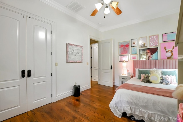 bedroom with crown molding, wood finished floors, baseboards, and a ceiling fan