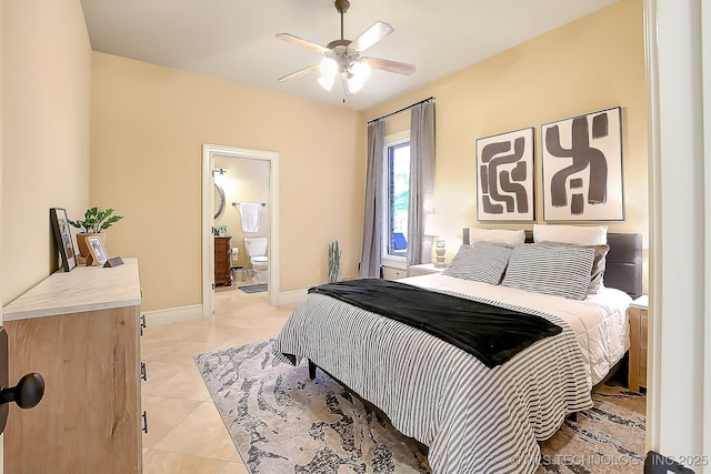bedroom with light tile patterned floors, connected bathroom, and baseboards